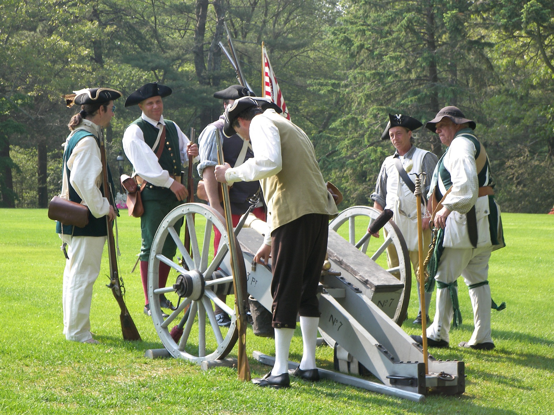 Revolutionary War re-enactors standing around cannon